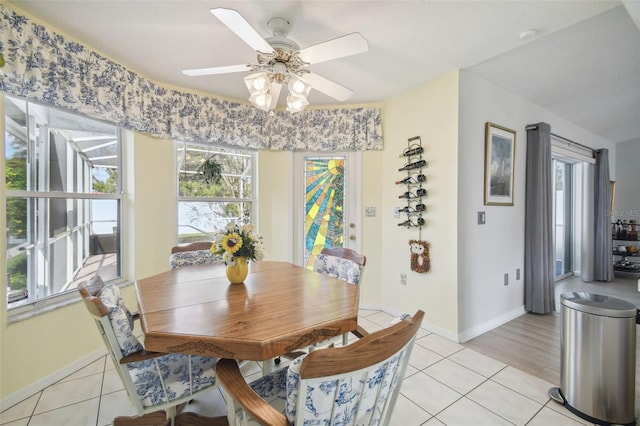 dining area with ceiling fan and light tile patterned flooring