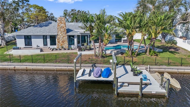 dock area featuring a water view, a patio area, and a lawn