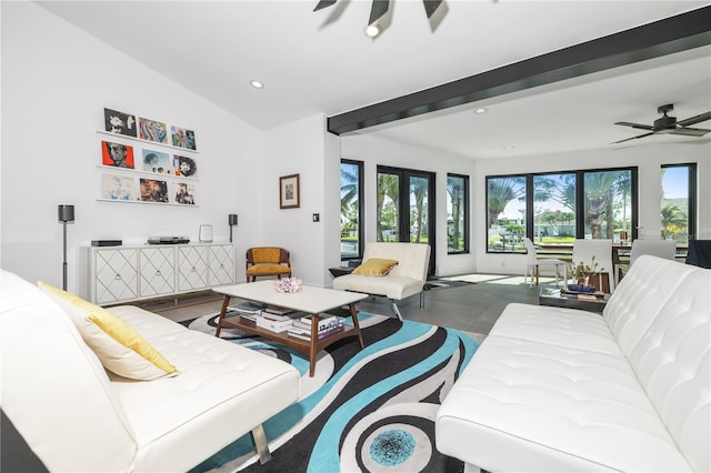 living room with ceiling fan, plenty of natural light, and lofted ceiling with beams