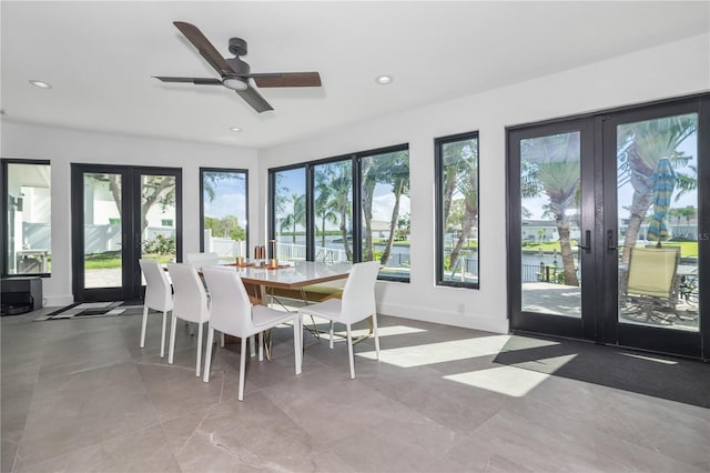 sunroom featuring ceiling fan and french doors