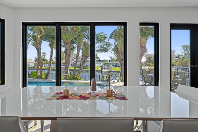 unfurnished dining area featuring a water view