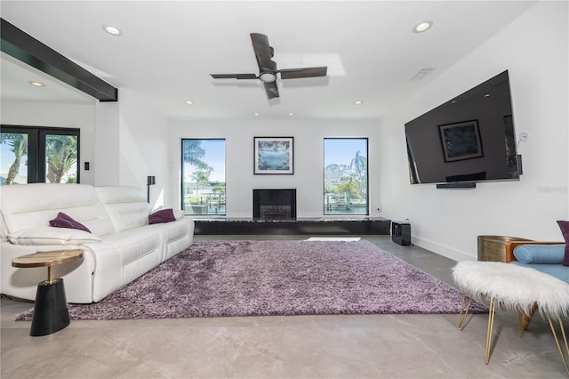 living room featuring plenty of natural light and ceiling fan