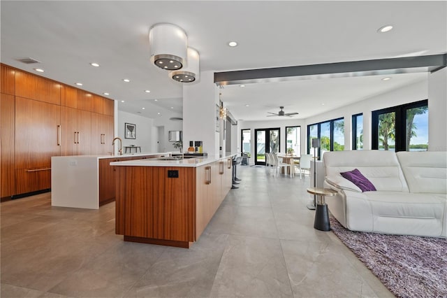 kitchen with ceiling fan and a large island