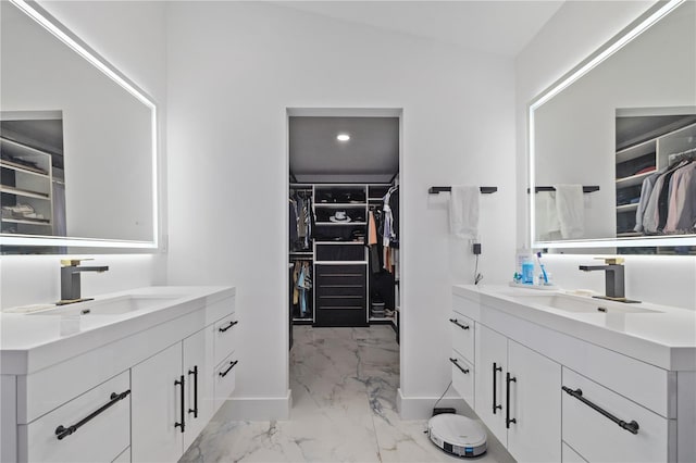 bathroom featuring vanity and lofted ceiling