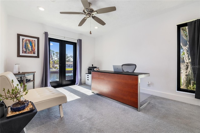 carpeted home office with ceiling fan and french doors