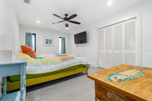 carpeted bedroom featuring a closet and ceiling fan