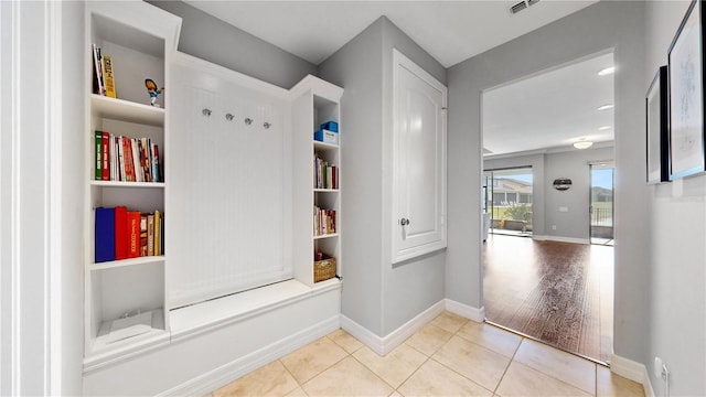 corridor featuring light tile patterned floors