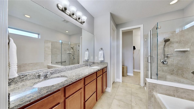 bathroom featuring vanity, tile patterned flooring, and plus walk in shower