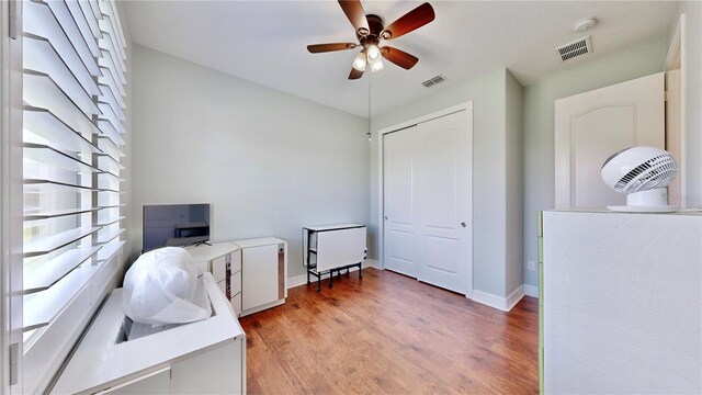 home office featuring ceiling fan and light hardwood / wood-style floors