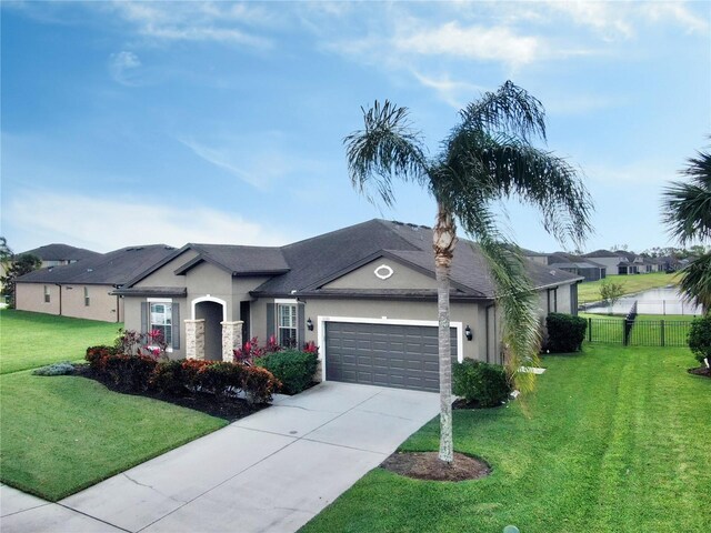 view of front of home with a garage and a front yard