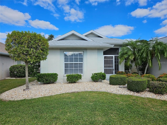 2421 E Del Webb Blvd, Sun City Center, FL 33573 - view of home's exterior featuring a yard, stucco siding, and roof with shingles