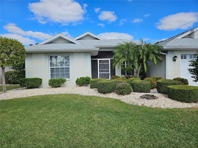 view of front of home featuring a garage and a front lawn