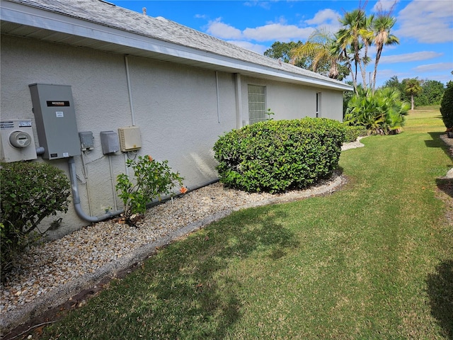 view of side of home with a yard