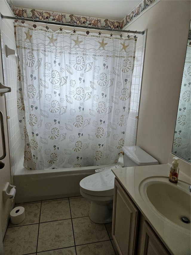 full bathroom featuring tile patterned flooring, tiled shower / bath combo, toilet, and vanity