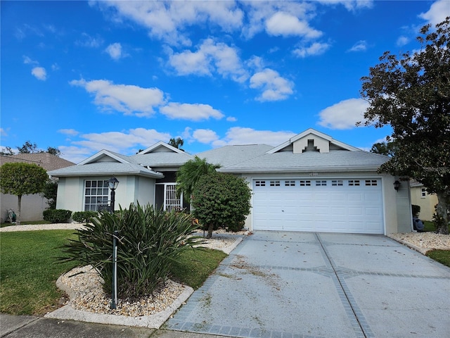 2421 E Del Webb Blvd, Sun City Center, FL 33573 - ranch-style home featuring concrete driveway, a garage, stucco siding, and a front lawn