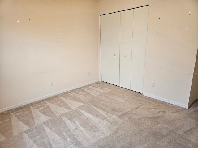 unfurnished bedroom with light colored carpet