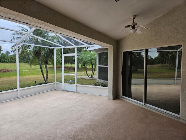 unfurnished sunroom featuring vaulted ceiling and ceiling fan