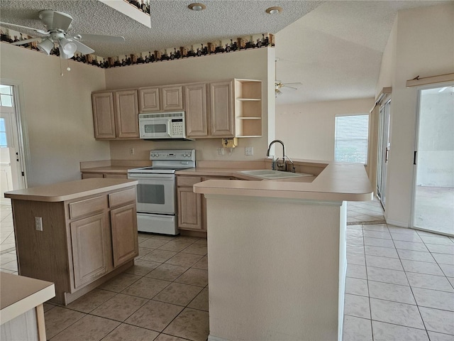 kitchen featuring light brown cabinets, white appliances, sink, light tile patterned floors, and kitchen peninsula