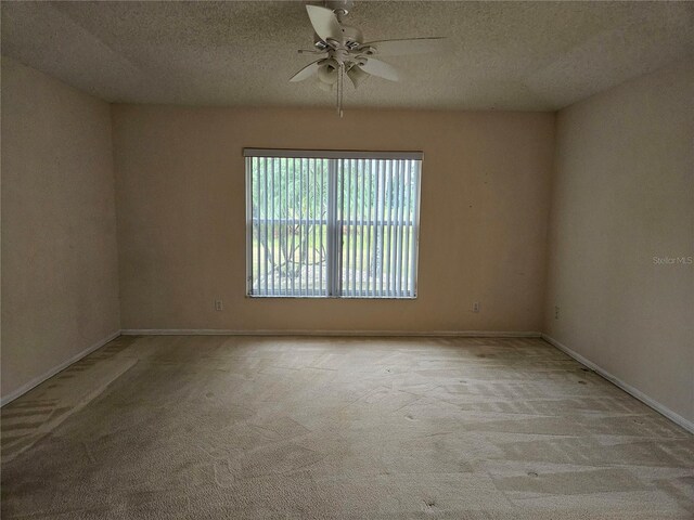 2421 E Del Webb Blvd, Sun City Center, FL 33573 - carpeted empty room with ceiling fan, a textured ceiling, and baseboards