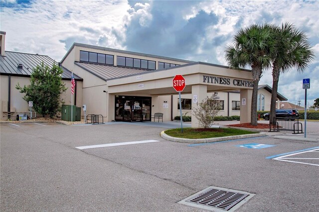 2421 E Del Webb Blvd, Sun City Center, FL 33573 - view of property featuring uncovered parking