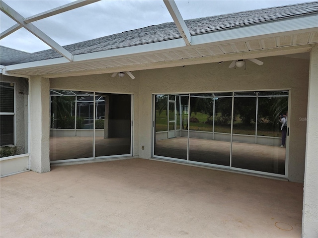 view of patio / terrace featuring glass enclosure and ceiling fan