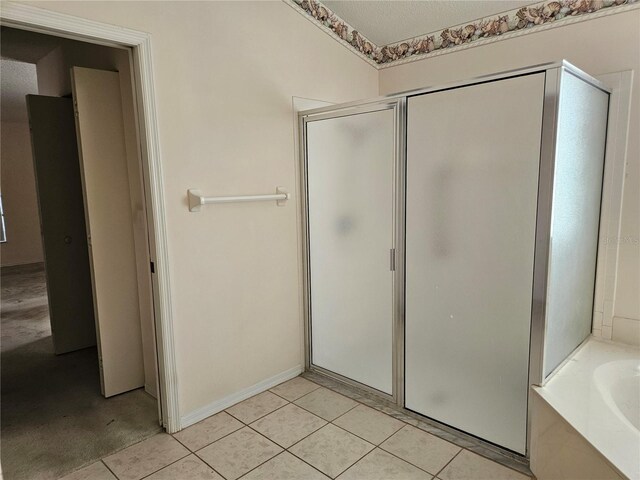2421 E Del Webb Blvd, Sun City Center, FL 33573 - full bathroom featuring a stall shower, tile patterned flooring, and a bath