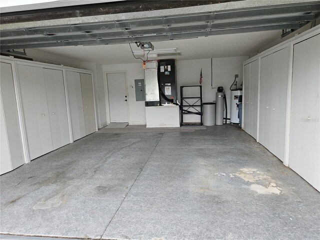 2421 E Del Webb Blvd, Sun City Center, FL 33573 - garage with electric panel, a garage door opener, heating unit, and water heater