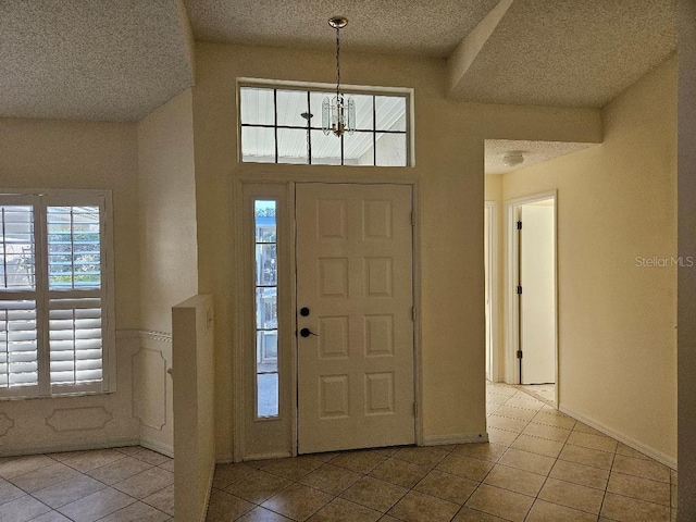 entrance foyer featuring a wealth of natural light and light tile patterned floors