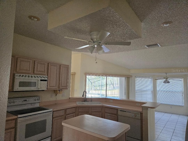 kitchen with sink, white appliances, light brown cabinetry, vaulted ceiling, and kitchen peninsula