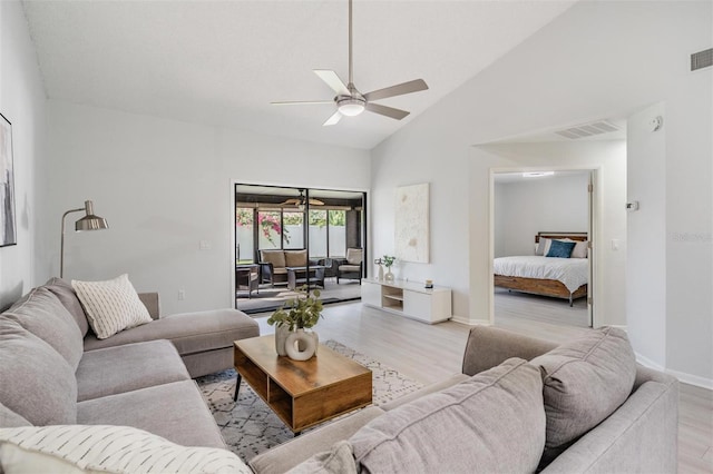 living room with high vaulted ceiling, light hardwood / wood-style flooring, and ceiling fan