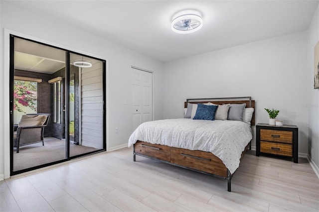 bedroom with access to outside and light wood-type flooring