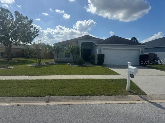 single story home with a garage and a front lawn