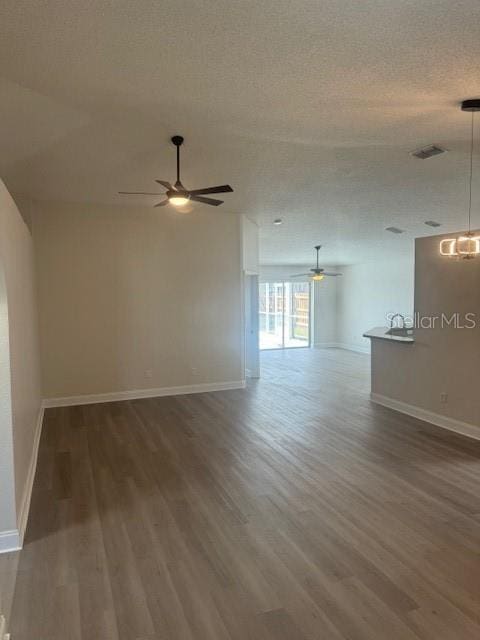 unfurnished room featuring wood-type flooring, a textured ceiling, and ceiling fan