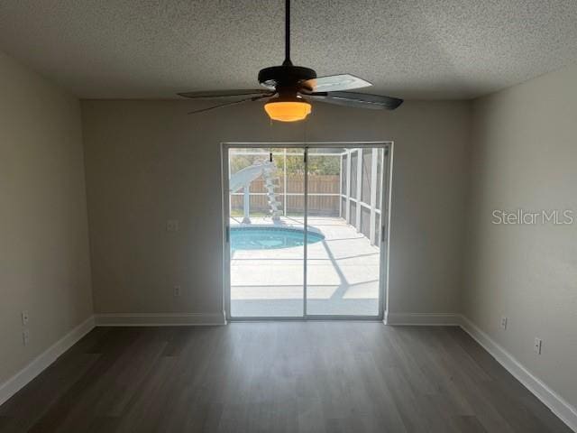 unfurnished dining area with ceiling fan, dark hardwood / wood-style floors, and a textured ceiling