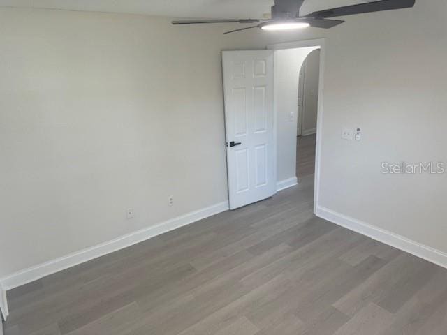 unfurnished room with hardwood / wood-style flooring and ceiling fan