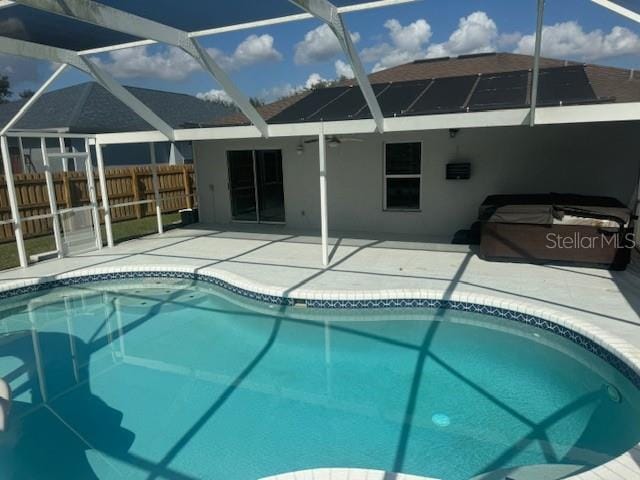 view of pool with a patio, a hot tub, and a lanai