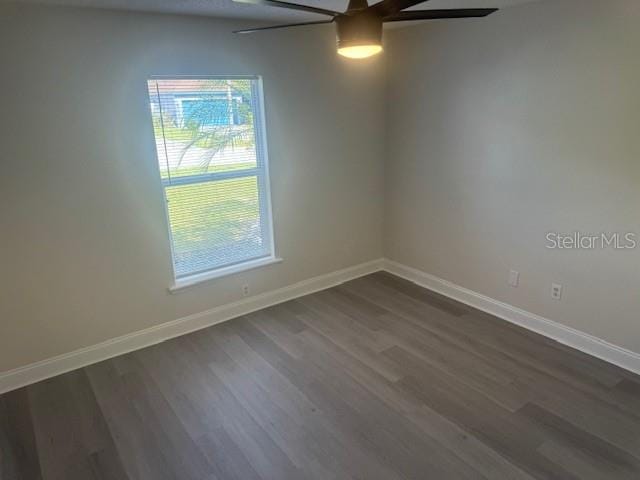 spare room featuring ceiling fan and dark hardwood / wood-style floors