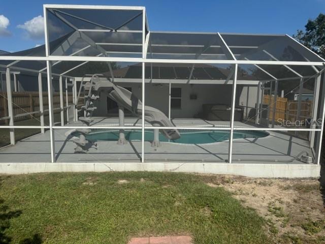 rear view of house featuring a yard, a patio, and a lanai