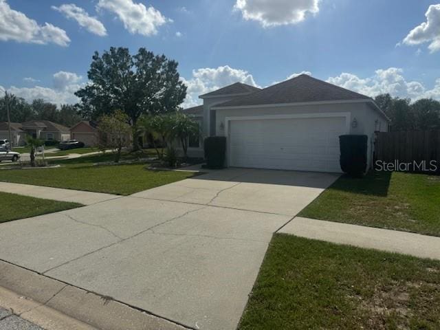 view of front of house with a front yard and a garage