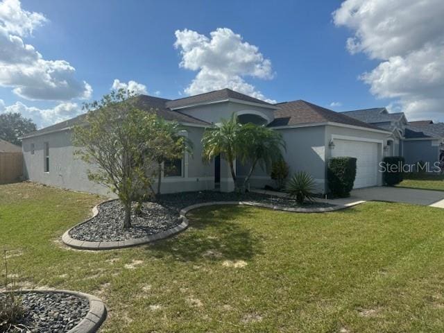 view of front facade with a front yard and a garage