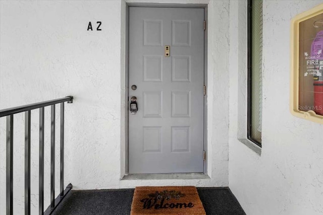 1127 Pine Ridge Cir W Unit A2, Tarpon Springs, FL 34688 - view of exterior entry featuring stucco siding