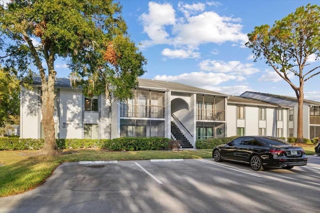 1127 Pine Ridge Cir W Unit A2, Tarpon Springs, FL 34688 - view of property featuring uncovered parking and stairs