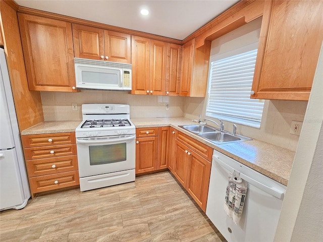 kitchen with white appliances, sink, and tasteful backsplash