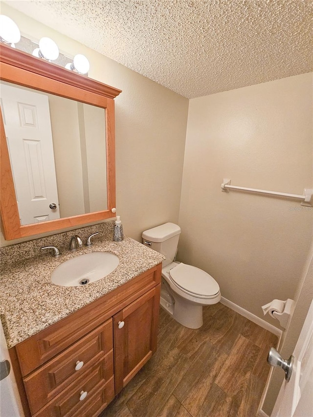 bathroom featuring vanity, a textured ceiling, and hardwood / wood-style flooring