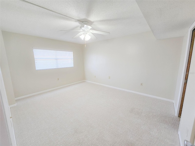 unfurnished bedroom with a textured ceiling, ceiling fan, and light carpet