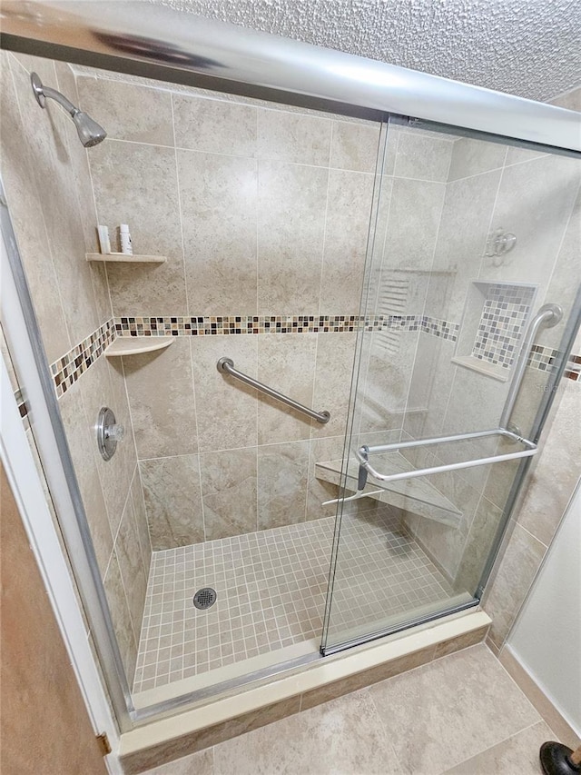 bathroom featuring tile patterned flooring and walk in shower