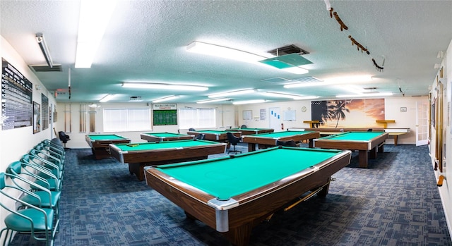 recreation room with dark carpet, a textured ceiling, and billiards