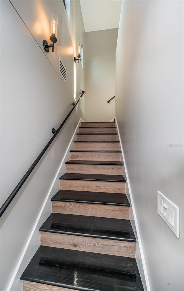 stairway with hardwood / wood-style flooring