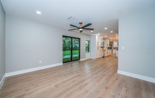 unfurnished living room with ceiling fan and light wood-type flooring