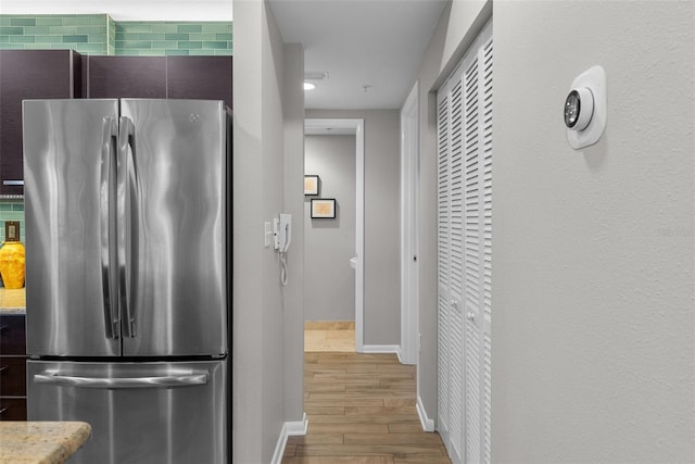 kitchen with stainless steel refrigerator and light hardwood / wood-style floors